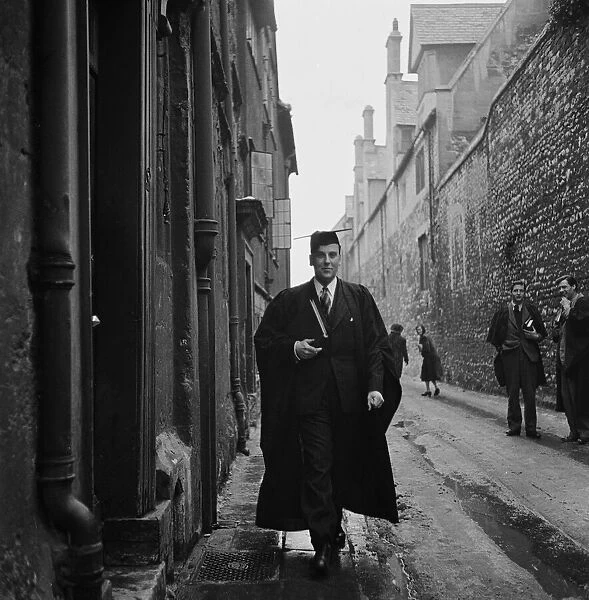 A student of Oxford University walks through one of the narrow back streets of the town