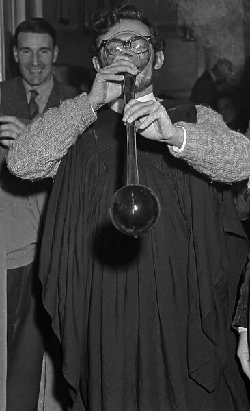 A student sinking a yard of ale at an unknown Cambridge pub. Circa May 1959