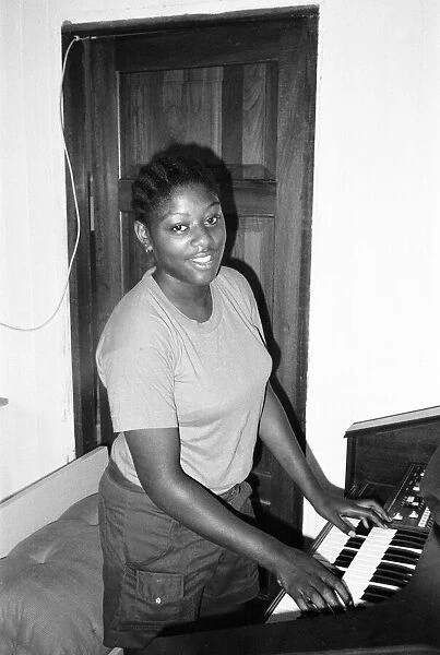 Student teacher plays the piano in Kingston, Jamaica, January 1984