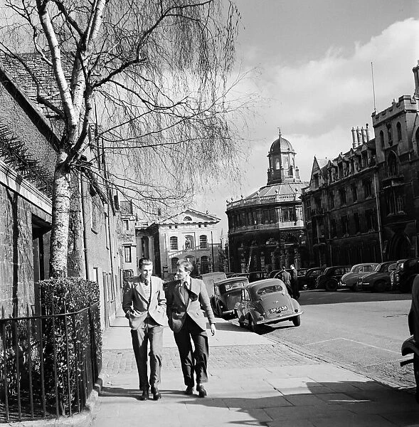 Two students of Oxford University walk near the Sheldonian Theatre at Broad Street