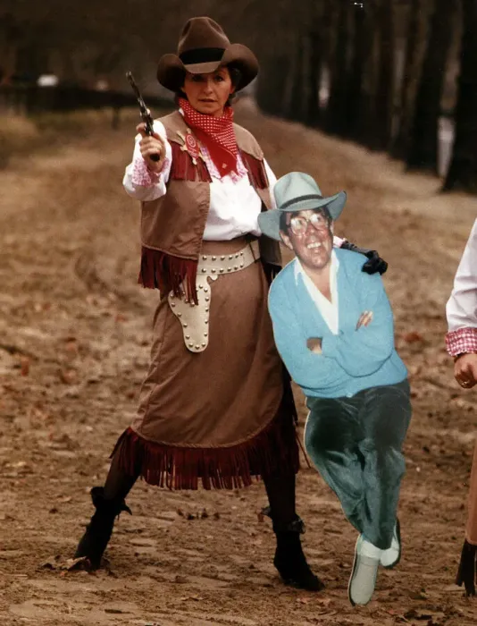 Framed Print : Sue Lawley TV Presenter dressed as a cowgirl with Hat and Gun holding a cardboard cutout