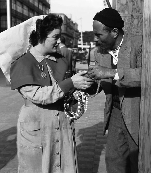 Suez Crisis 1956 British Army nurse Rita Kelly of Dublin haggles with a trader in