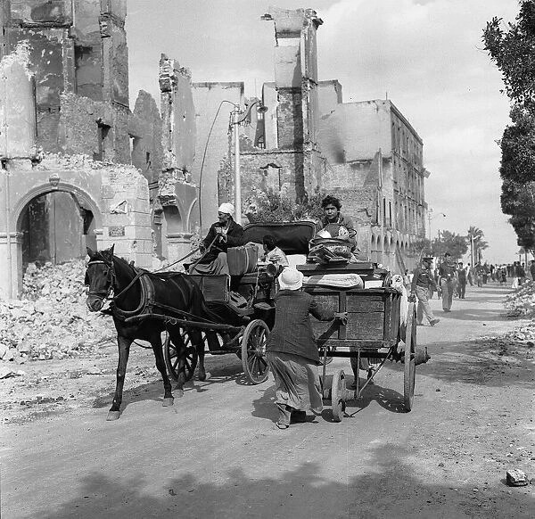 Suez Crisis 1956 Egyptian refugees remove their belongings in carts in the bomb