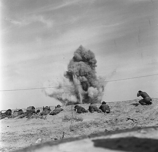 Suez Crisis 1956 Royal Engineers take cover as they blow up a mine from a beach