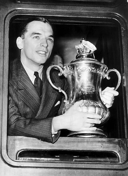 Sunderland captain Raich Carter with the FA Cup trophy on his way back to Sunderland by