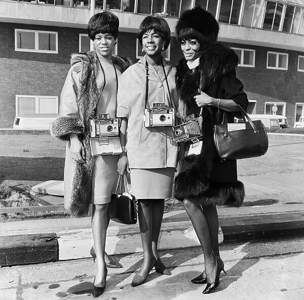 The Supremes pictured here each with a Polaroid Camera around their neck