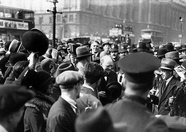Surrounded by an excited crowd, Home Secretary Winston Churchill walks into the House of