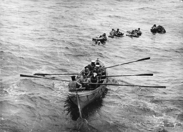 Survivors of an R. A. F. Sunderland flying boat being rescued by the crew of a destroyer