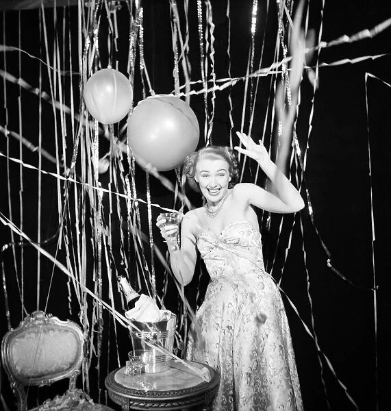 Susan celebrates the New Year with champagne and balloons January 1950