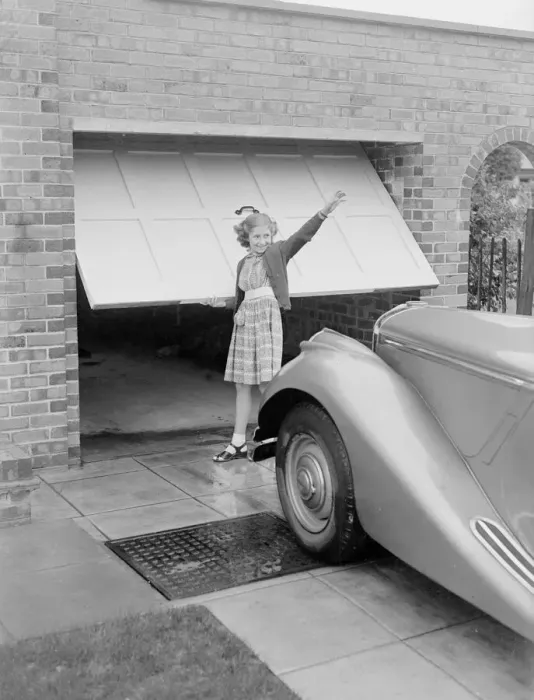 Framed Print : Susan Davies seen here opening the garage door for her father Framed Print : Susan Davies seen here opening the garage door for her father