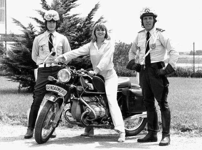 Framed Print : Susan Penhaligon, film actress July 1977 borrows a motorbike from two gendarmes during a Framed Print : Susan Penhaligon, film actress July 1977 borrows a motorbike from two gendarmes during a