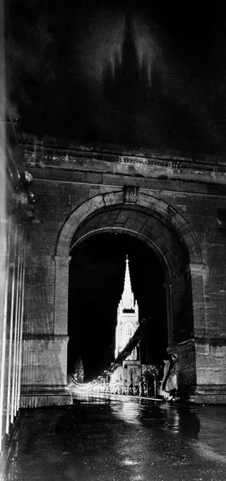 Framed Print : Through the suspension bridge arch under which two girls shelter All Saints Church Framed Print : Through the suspension bridge arch under which two girls shelter All Saints Church
