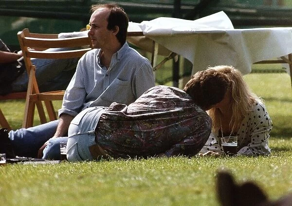 Suzanne Dando TV Presenter with boyfriend Christopher Qakes laying on grass kissing
