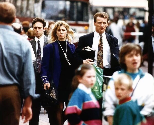 Suzanne Dando TV presenter with boyfriend Christopher Oakes walking down crowded street