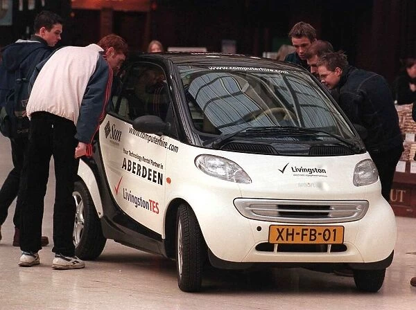 Swatch smart car in Glasgow central station January 1999 crowd looking in