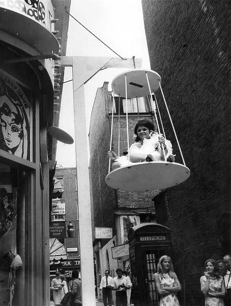 Sylvia Bryan in her birdcage outside the boutique. July 1967 P006383