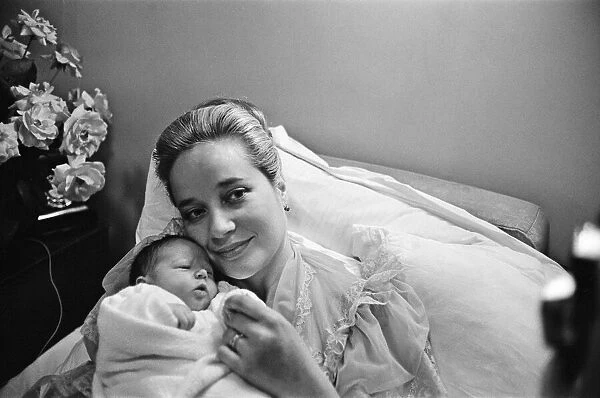 Sylvia Syms, actor and star of Ice Cold In Alex, with her new born baby daughter Beatrice