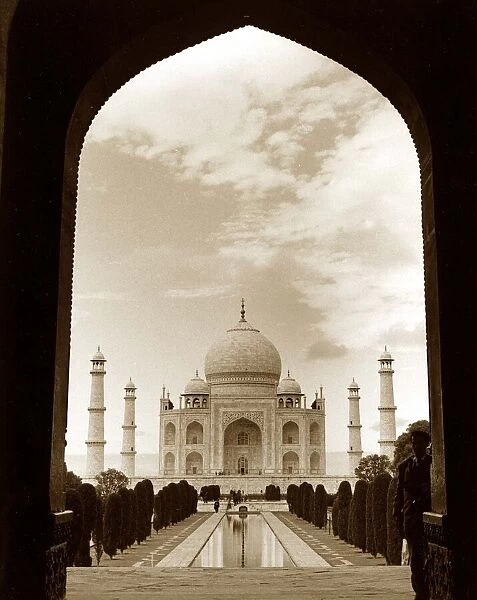 The Taj Mahal in India seen through the Arch - Front view of Building