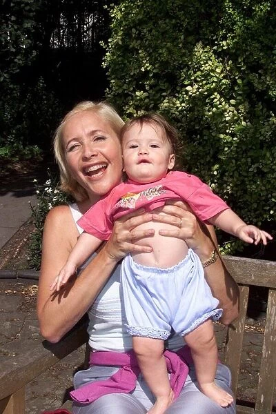Tania Bryer TV Presenter July 1999 holding baby daughter Natasha Joy Moufarrige at