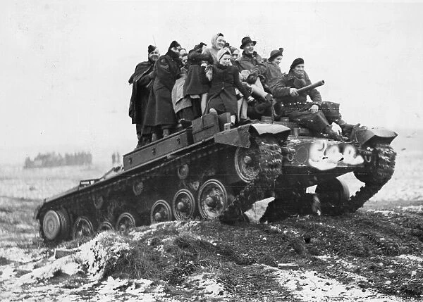 A tank carrying munition workers to mimic a battle arranged for the benefit of