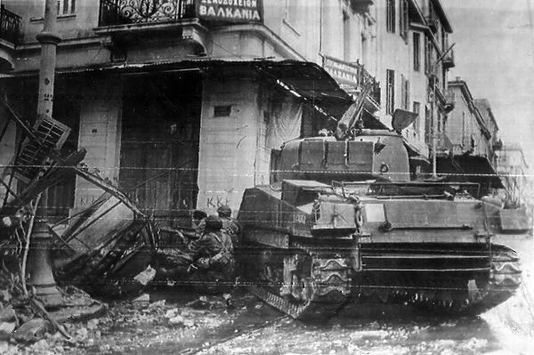 A tank gives cover to paratroopers as they probe the ruins of a dynamited house n Athens