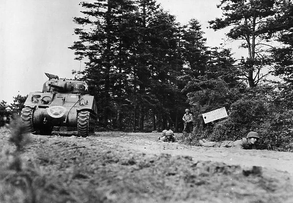 US tanks and infantry move up near Saint-Jores, France with supporting infantrymen