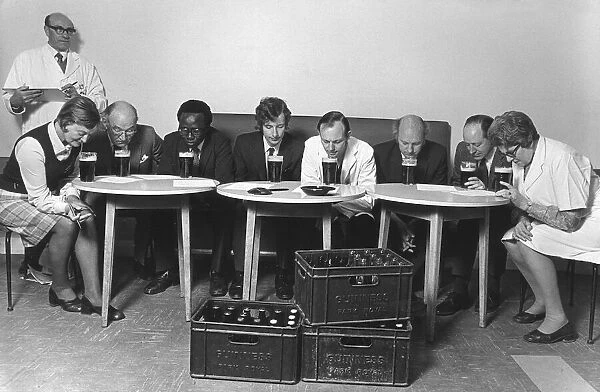 A tasting panel of men and women smell the aroma from glasses of Guiness at the Park