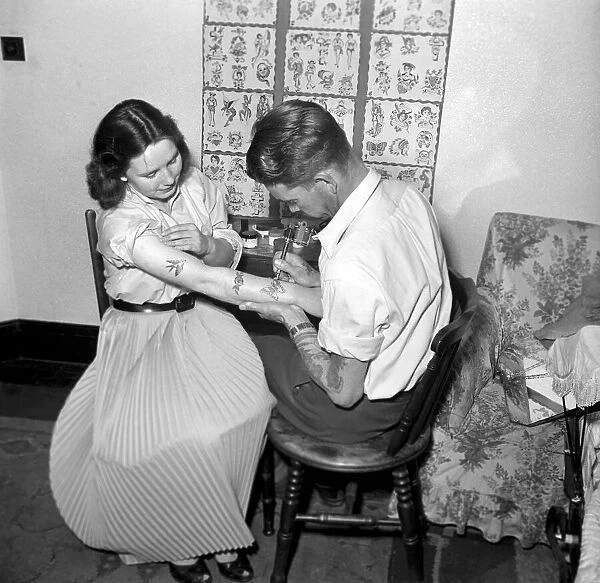Tattoo artist D. A. Deller seen here at work in his St. Leonards Studio. June 1957 A416