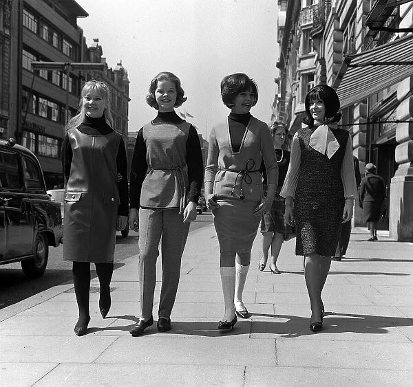 Teenage Fashion in the sixties Four young women walk downt the street - two are
