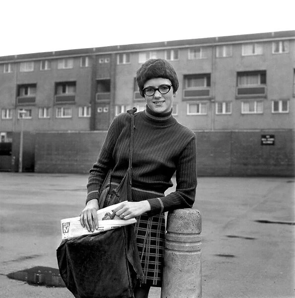 Teenage girl from Toxteth in Liverpool delivering newspapers on a paper round