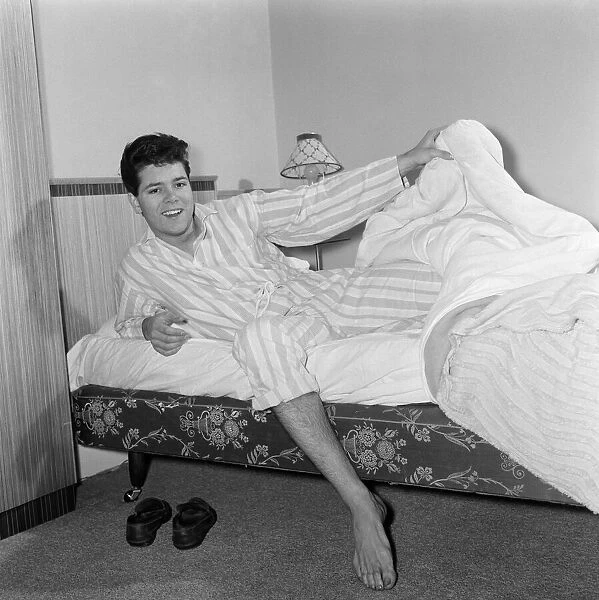 Teenage pop idol Cliff Richard relaxes on his divan at his Winchmore Hill home