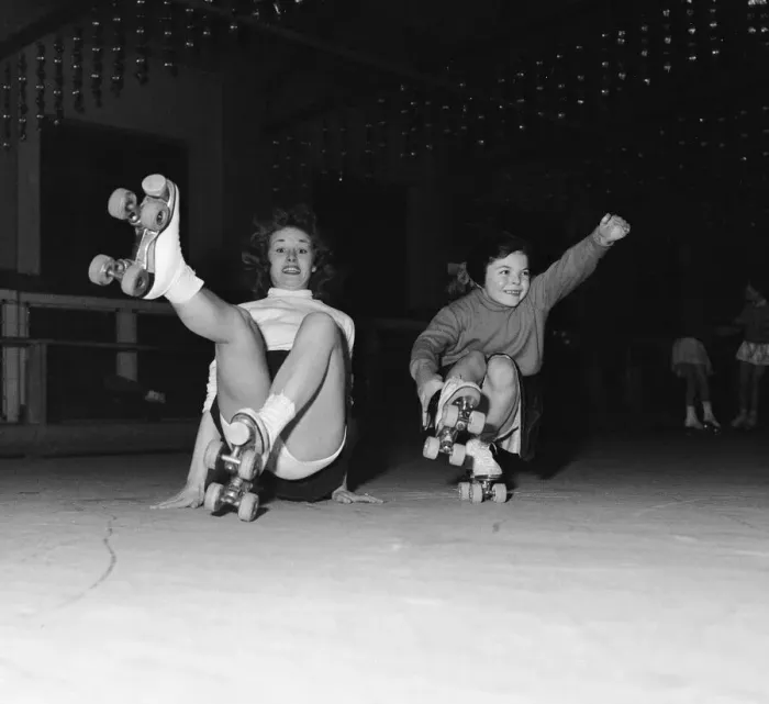 Framed Print : Teenager Betty Jones pictured roller skating with seven year old Anne Morgan at the rink Framed Print : Teenager Betty Jones pictured roller skating with seven year old Anne Morgan at the rink