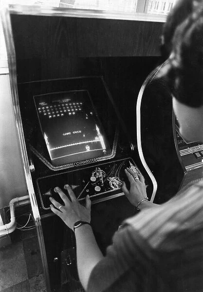 A teenager plays Space Invaders at an amusements arcade in Cardiff June 1981