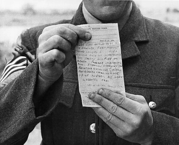 A telegram message from the front, shown to camera by an officer