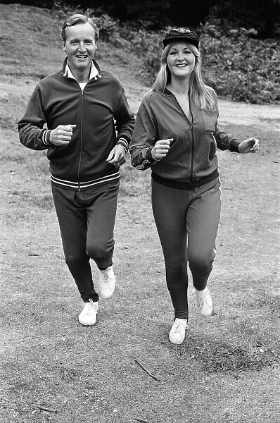 Television personality Nicholas Parsons jogging with his daughter. September 1976