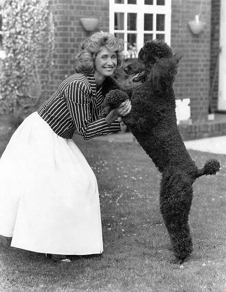 Television presenter and news reader Jan Leeming at home with her dog