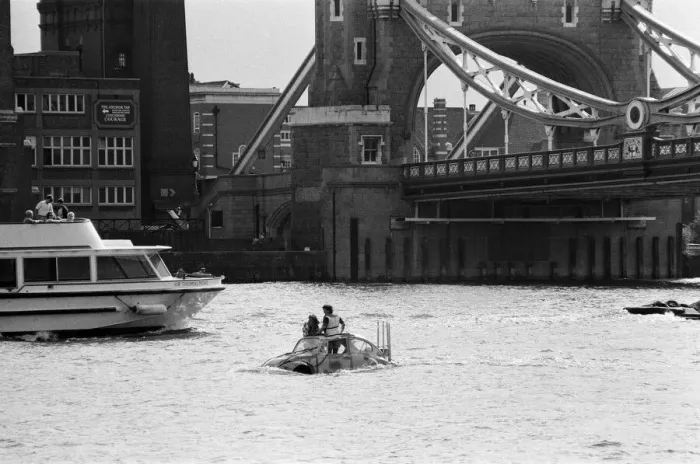 Framed Print : Television presenter Peter Duncan in a VW Beetle car in the River Thames