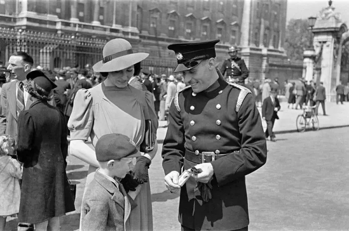 Framed Print : Temporary fireman Skillern receives George medal at the Palace, with his wife and child Framed Print : Temporary fireman Skillern receives George medal at the Palace, with his wife and child