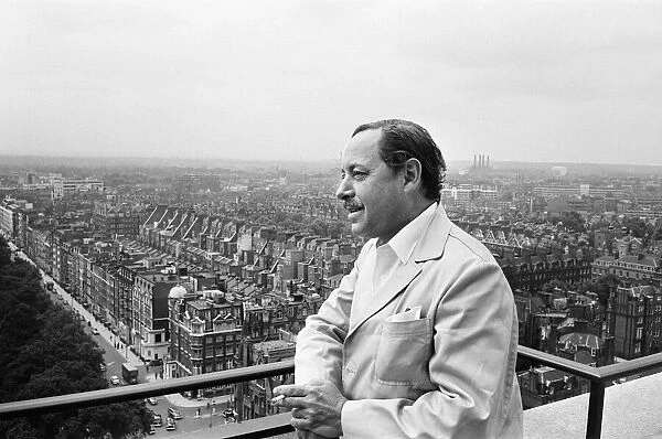 Tennessee Williams enjoys the view from the balcony of the Carlton Tower Hotel, London