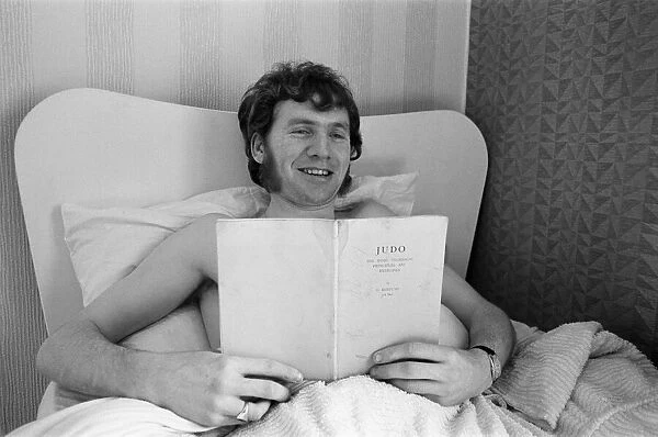 Terry Conroy of Stoke City, in bed with flu, catches up on his reading ahead of FA Cup