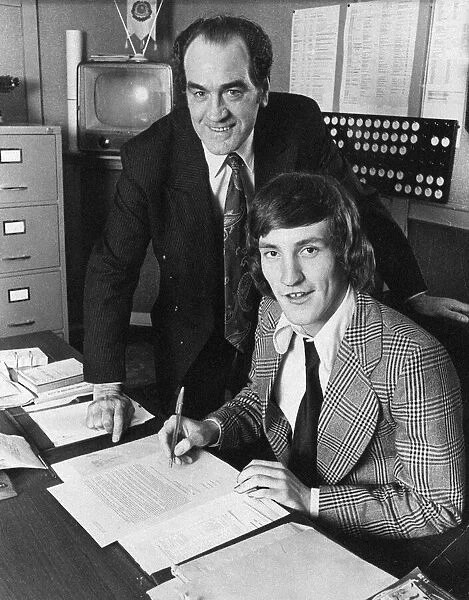 Terry McDermott signs for Newcastle United, watched by manager Joe Harvey