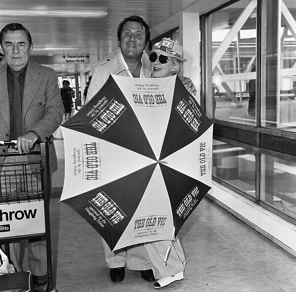 Terry Scott and June Whitfield arriving at Heathrow Airport from Hong Kong