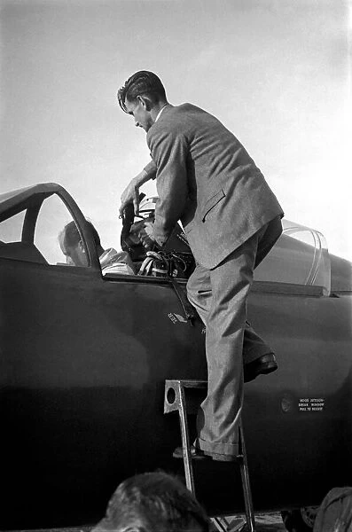 Test pilot Neville Duke in the cockpit of a Hawker Hunter jet fighter for an attempt