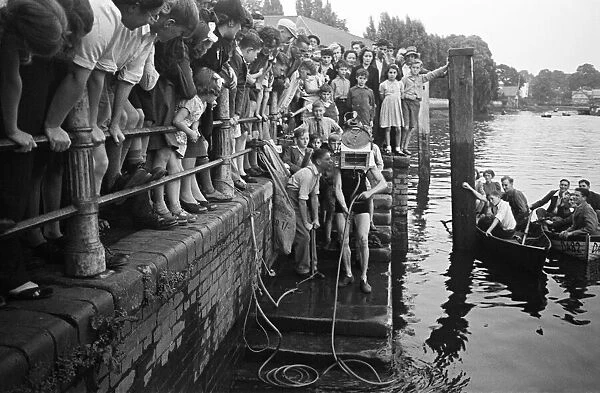 Testing out home made diving equipment, with crowds watching. Wiltshire. Circa 1945