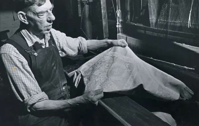 Framed Print : Textile Industry Ireland - worker holds up some material Weaving Cloth