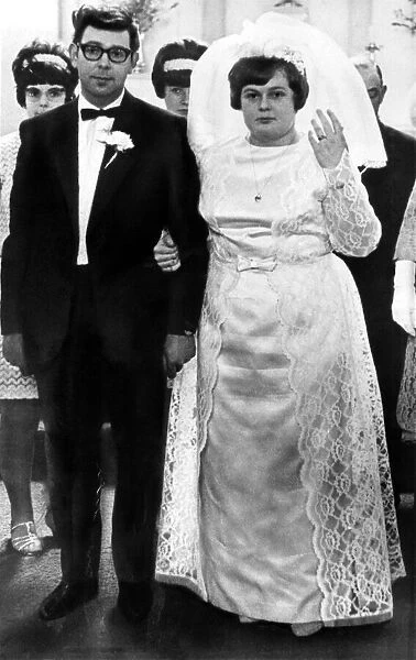 Then: Nervous expressions as the couple pose for the wedding-day picture that Margaret