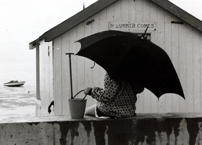 Framed Print : Thorpe Bay in Essex - April 1970 Holidaymaker on the beach with an umbrella Framed Print : Thorpe Bay in Essex - April 1970 Holidaymaker on the beach with an umbrella