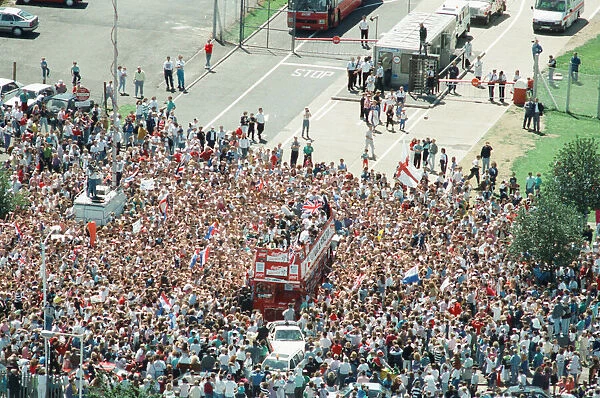 Thousands of England football fans line the streets near Luton airport to welcome their