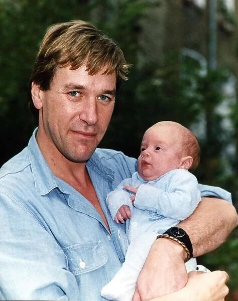 Tim Bentinck with his four months old son Jasper at home in the garden September