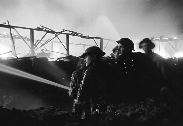 Timber Fire being put out after raid. 25th October 1940